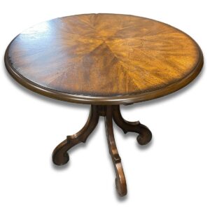 Used 31" Round Traditional Distressed End Table in Wood Finish A classic silhouette and a distressed wood finish, this round end table brings a timeless look to any room. Its sturdy build and rich tone make it both practical and attractive for accenting furniture groupings. Traditional round design Distressed wood finish Sturdy, solid wood construction Dimensions: 31" Diameter x 29"H Ideal for waiting rooms, reception areas, and traditional lounge spaces.