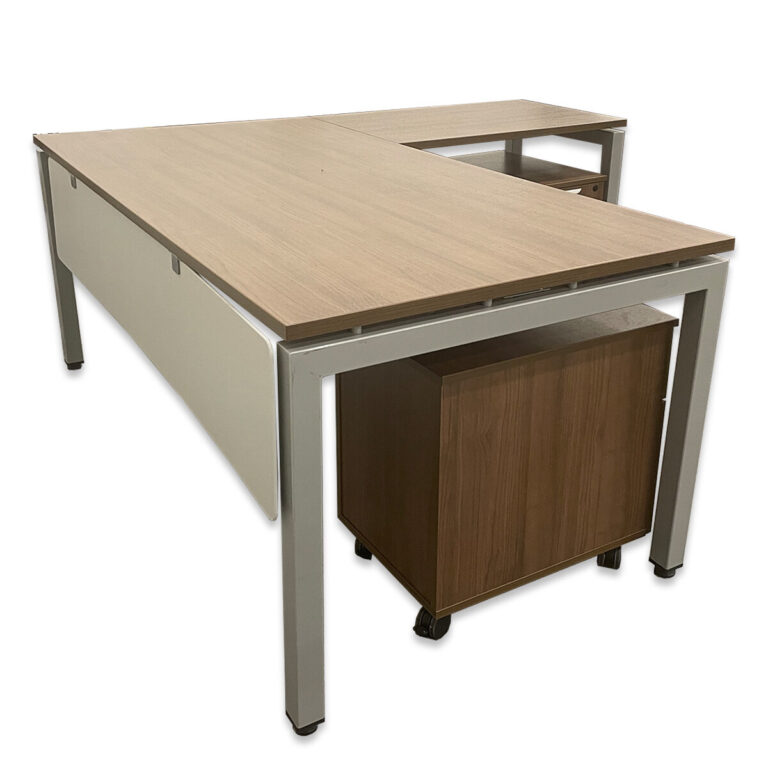 Used 73"W Walnut L-Shape Desk w/ Modesty Panel & Two Mobile Box/File Pedestals This L-shaped desk provides a spacious workstation with a clean, open-leg design and a light gray modesty panel. Includes two mobile box/file pedestals for flexible storage and workspace organization. Walnut laminate surface with silver frame Includes (2) mobile box/file pedestals Modesty panel for privacy and support Scratch- and stain-resistant laminate finish Commercial-grade construction Overall Dimensions: 73"W x 73"D x 31"H Perfect for offices, executive suites, or collaborative workspaces.