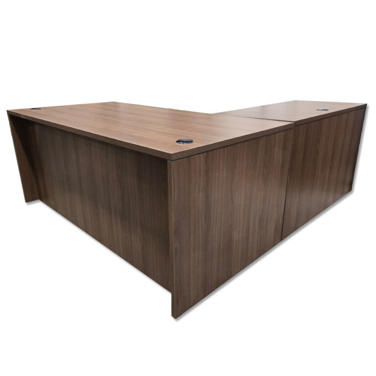 Used 71" W L-Shaped Desk In Walnut - Left Hand Return This L-shape workstation provides a practical layout with integrated storage and a generous surface area for daily tasks. Full workstation footprint with left-hand return Two hanging box/file pedestals with locking drawers Walnut laminate surface Desk grommets for cable management  Commercial construction suitable for office use Dimensions Main Desk: 71" W x 35.5" D x 29.5" H Return: 47" W x 23.5" D x 29.5" H Perfect for offices, executive suites, and collaborative workspaces.