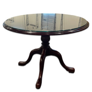 Used 43" W Cherry Red Round Glass Top Table This round table features a clear glass top set on a cherry red wood base with a four-leg pedestal design. Its sturdy build and polished finish make it a refined addition to professional or residential environments. Clear glass top Cherry red wood base Four-leg pedestal design Dimensions: 43"W x 43"D x 31"H Perfect for reception areas, meeting spaces, or residential living areas.