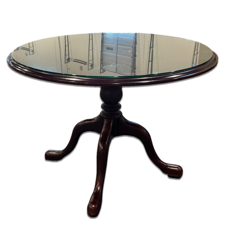Used 43" W Cherry Red Round Glass Top Table This round table features a clear glass top set on a cherry red wood base with a four-leg pedestal design. Its sturdy build and polished finish make it a refined addition to professional or residential environments. Clear glass top Cherry red wood base Four-leg pedestal design Dimensions: 43"W x 43"D x 31"H Perfect for reception areas, meeting spaces, or residential living areas.