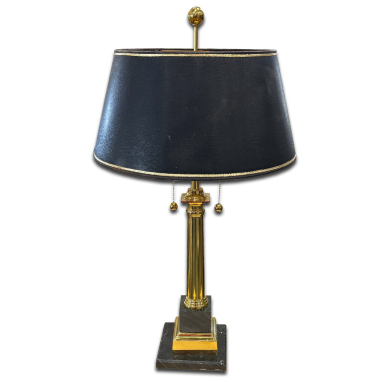Used 29" H Black & Gold Table Lamp This elegant lamp features a gold column base with a square black marble platform and a black shade trimmed in gold. Dual pull chains offer easy operation, adding a refined touch to desks or side tables. Gold column base with marble-style footing Black shade with gold trim Dual pull chain switches Dimensions: 16"W x 16"D x 29"H Perfect for executive offices, reception areas, or traditional interiors.