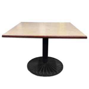 Used 42" W Square Breakroom Table with Round Black Base – Tan Laminate Top  Sturdy breakroom table with a neutral surface and mahogany edge banding. Ideal for shared spaces and casual seating. 42" W square top with tan laminated surface Mahogany veneer banding Black round pedestal base for stability Dimensions: 42"W x 42"D x 30"H Perfect for cafés, lunchrooms, or collaborative break areas. --  Product Disclaimer:  Color Representation: Please note that actual product colors may vary slightly from what appears on your screen. This variation can occur due to differences in monitor settings, screen resolutions, device types, and lighting during photography. While we strive for accuracy in our images, we cannot guarantee that the color you see precisely matches the product. By purchasing from our website, you acknowledge this potential for minor color variation and agree that such differences do not constitute a defect or misrepresentation. Used Products: Used Furniture May show signs of cosmetic wear such as scratches, scuffs, or other minor imperfections. These products are fully functional and operate as intended. Some items may have been floor models or store returns. 