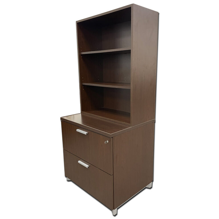 Used National Bookcase Lateral File Combo – Espresso Finish, Locking File, Adjustable Shelves Functional and space-saving storage unit combining a two-shelf bookcase with a secure lateral file drawer. Finished in rich espresso laminate with gray metal pull handles, this piece offers both open and enclosed storage for a polished, professional look. Finish: Espresso laminate Hardware: Gray metal pull handles Features: Locking lateral file, two adjustable shelves Dimensions: 30″W x 24″D x 67″H Ideal for executive offices, reception areas, or workspaces needing a combination of display shelving and secure document storage.