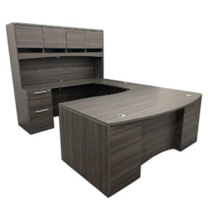 Used 71"W CorpDesign Grey U-Shape Bowfront Desk With Hutch - LH  Executive U-shape desk set finished in grey laminate with a bowfront design and overhead hutch for storage. Includes soft-close drawers, a box/box/file pedestal, and a file/file pedestal for complete organization. U-shape configuration with bowfront desk and left-hand return Overhead hutch with doors for storage and display frosted glass topper Soft-close drawers for smooth, quiet operation Includes (1) box/box/file pedestal and (1) file/file pedestal Dimensions: Desk: 71"W x 42"D x 30"H Bridge: 42"W x 20"D x 30"H Credenza: 71"W x 24"D x 30"H Hutch: 71"W x 15"D x 41"H Ideal for executive offices, private offices, and professional workspaces.