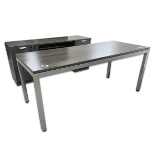 Used 72" W Desk and Credenza Set in Grey Woodgrain  A practical matching desk and credenza set designed for modern office environments. The desk features a clean grey woodgrain laminate top with silver metal legs, while the double pedestal credenza provides file, file drawer storage. Grey woodgrain laminate finish Desk includes silver metal legs and dual grommets Double Pedestal Credenza - (2) File/file Pedestal  Matching modern design suitable for commercial settings Dimensions:  Desk: 72″W x 30″D x 29½″H Credenza: 68″W x 22″D x 29½″H Perfect for executive offices, workstations, and collaborative environments.