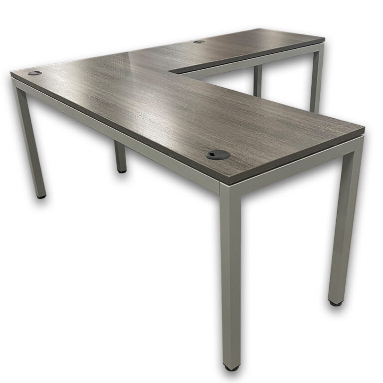 Used 71" W L-Shape Desk W/ Metal Frame - Grey Woodgrain  This L-shaped desk provides a spacious 71" W work surface with integrated grommets for cable management, making it a practical setup for daily office use. L-shaped configuration with main desk and return Neutral grey woodgrain laminate work surface Metal leg base with open leg clearance Built in grommets for power and data Dimensions: Main Desk: 71" W x 24" D x 30" H Return: 47" W x 24" D x 30" H Perfect for private offices, home offices, and collaborative workspaces.