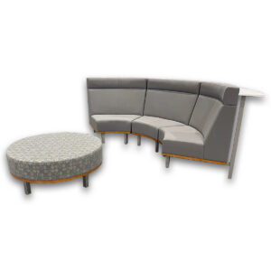 Used Curved 3-Piece Bench With Integrated Rear Worksurface & Round Ottoman - Grey Modular curved seating creates a collaborative waiting or lounge area with integrated surface space and coordinating ottoman. Three-piece curved bench configuration with supportive back panels White laminate worksurface for light work or casual meetings Coordinating round upholstered ottoman included Sturdy metal leg supports with wood accent base Dimensions: Bench section 55W x 32D x 44 1⁄2H Round ottoman 42 diameter x 18H Ideal for offices, reception areas, and collaborative workspaces.