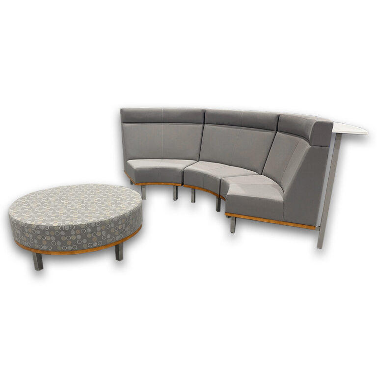 Used Curved 3-Piece Bench With Integrated Rear Worksurface & Round Ottoman - Grey Modular curved seating creates a collaborative waiting or lounge area with integrated surface space and coordinating ottoman. Three-piece curved bench configuration with supportive back panels White laminate worksurface for light work or casual meetings Coordinating round upholstered ottoman included Sturdy metal leg supports with wood accent base Dimensions: Bench section 55W x 32D x 44 1⁄2H Round ottoman 42 diameter x 18H Ideal for offices, reception areas, and collaborative workspaces.
