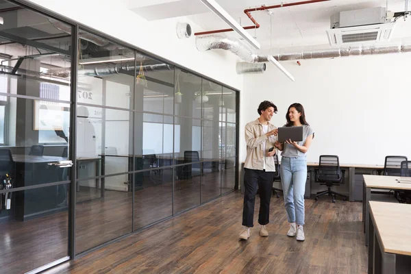 A man and woman working in a modular office